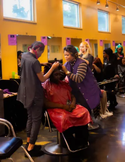 Two Pro Way Students work on a clients hair.